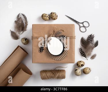 Gift boxes in craft paper and natural decorations, creative and zero waste Easter present wrapping. Stock Photo