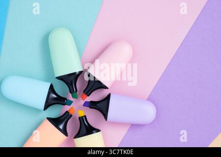 Paste colorl marker pens on multi-colored background. Multi-colored highlighter, close-up Stock Photo