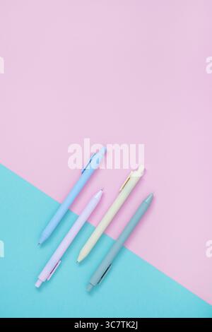 Set of pastel ballpoint pen on light pink and blue colors. Stationery background. Flatly, copyspace. Stock Photo