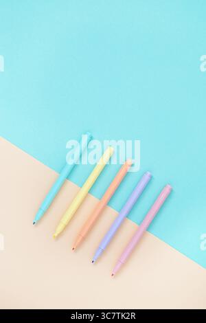 Set of pastel markers felt-tip pens on light yellow and blue colors. Stationery background. Flatly, copyspace. Stock Photo