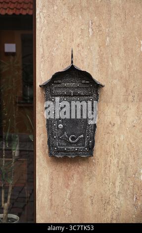 Forged mailbox on the wall of the house Stock Photo