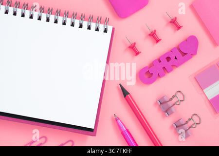 Empty notebook page for your text with pink school and office stationery on pink background. Eraser in form of flamingo. Flatly. Stock Photo