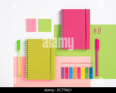 Knolling composition with different school stationery on pink and green background. Back to school Stock Photo