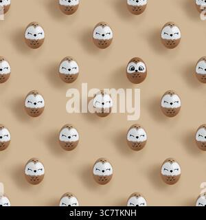 A pattern of Easter eggs in the form of owls on a pastel beige background Stock Photo