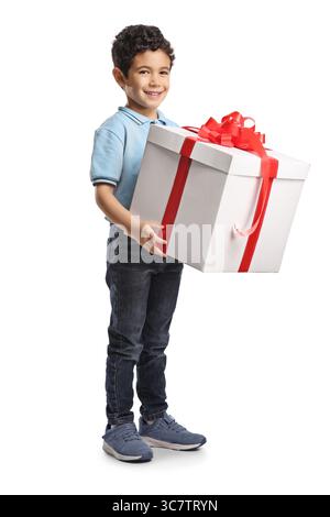 Full length shot of a boy holding a big gift box isolated on white background Stock Photo