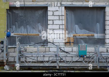 A Construction Site Featuring Unfinished Windows and Scaffolding Elements Awaiting Completion Stock Photo