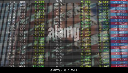 Displaying digital financial data grid covering desktop monitor, with colored market indicators Stock Photo