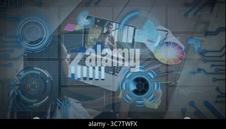 Designer working remotely on office desk, with laptop, color wheel, colored pencils, sticky notes Stock Photo