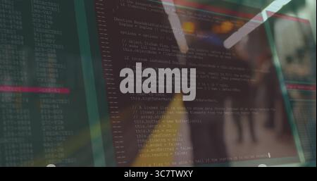 Displaying transparent monitor showing code in office hallway, glass partitions and overhead lights Stock Photo