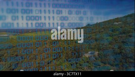 Displaying binary code overlay blending grassy plains, rolling hillside showing glowing blue digits Stock Photo