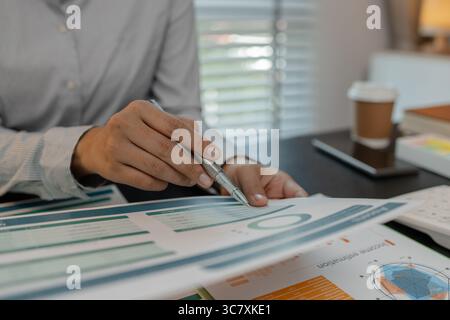businessman is checking financial documents to match the information summarized by the accounting department, accountant, marketing department, workin Stock Photo