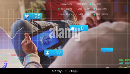 Analyzing man using tablet while viewing blueprint and social icons in home lounge, copy space Stock Photo