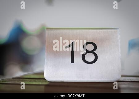 Table number 18 at a restaurant. Ready for service. Stock Photo