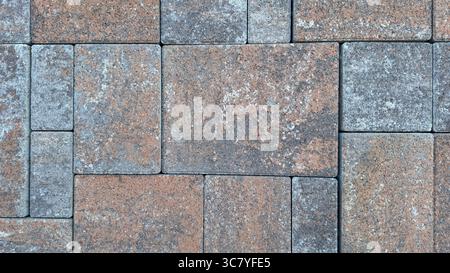 Patterned brick pavement with rustic textured stones in earthy tones Stock Photo