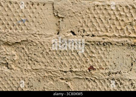 Textured close-up of beige painted brick wall surface detail Stock Photo