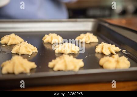 Close-up of homemade star shaped butter cookies on a baking tray ready to put in the oven Stock Photo