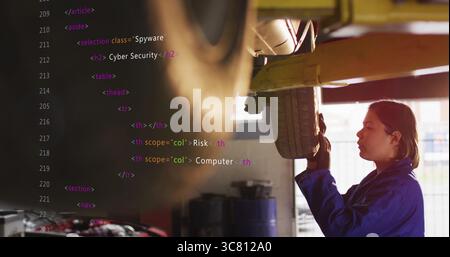 Female mechanic in blue coverall examining vehicle underside in shop with HTML overlay, copy space Stock Photo