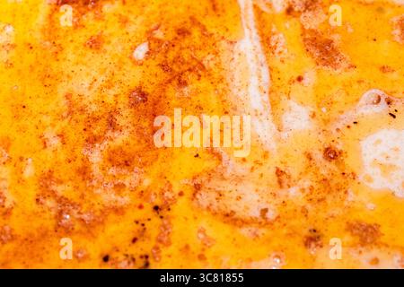 Close-Up of Melted Butter with Paprika and Spices Forming a Flavorful Swirl Stock Photo
