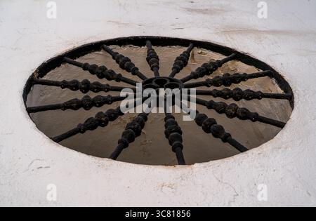 Decorative Circular Iron Grate Over a Window Well in Cordoba, Spain Stock Photo
