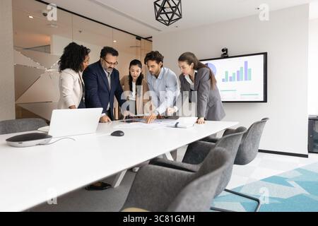 Multiethnic business team discuss work around table in conference room Stock Photo