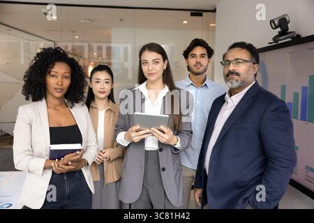 Group portrait serious confident multiethnic businesspeople team looking at camera Stock Photo