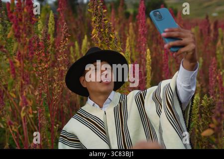 Young latin american farmer taking a selfie in a quinoa field Stock Photo