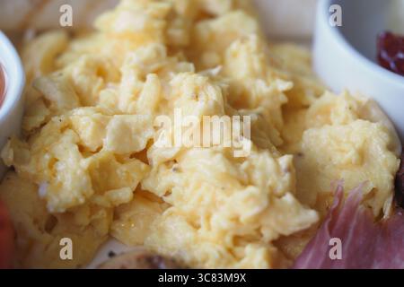 Delicious scrambled eggs served with breakfast sides Stock Photo