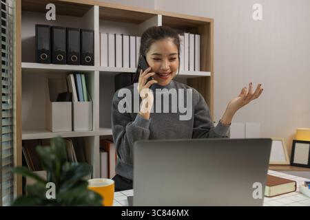 happy woman working on laptop at home office, entrepreneur using laptop at home office, mature businesswoman working from home, beautiful company owne Stock Photo
