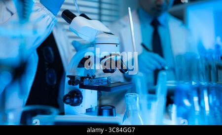 lab, scientist working on scientific equipment in modern laboratory, International team of scientists working together in medical laboratory doing res Stock Photo