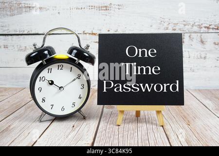 One Time Password text with easel and alarm clock on wooden background Stock Photo