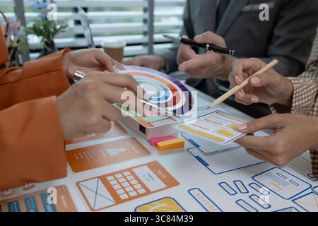 the development team is consulting on the design of the website UX UI, they are working on project of ux ui, interface, innovation of ux ui, develop t Stock Photo