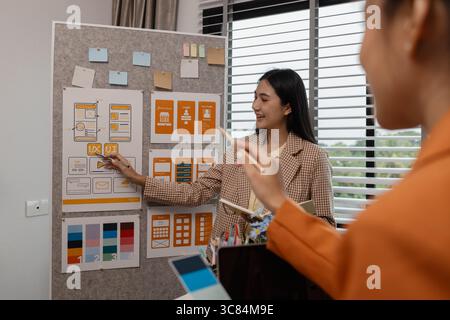 ux developer and ui designer brainstorming about mobile app interface wireframe design in the office, website designer, creative planning phone app de Stock Photo