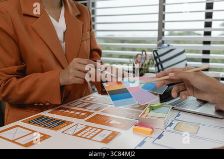 the development team is consulting on the design of the website UX UI, they are working on project of ux ui, interface, innovation of ux ui, develop t Stock Photo