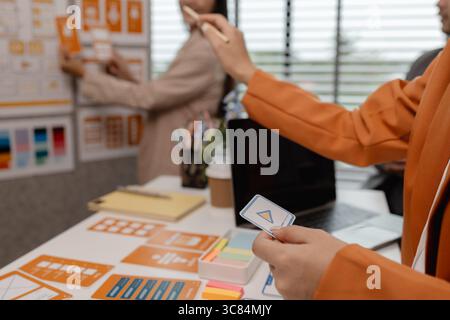 ux developer and ui designer brainstorming about mobile app interface wireframe design in the office, website designer, creative planning phone app de Stock Photo