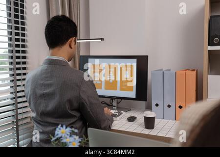 ux developer and ui designer brainstorming about mobile app interface wireframe design in the office, website designer, creative planning phone app de Stock Photo