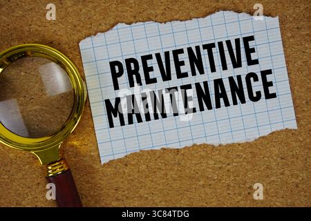Preventive Maintenance text written on paper with magnifying glass Stock Photo