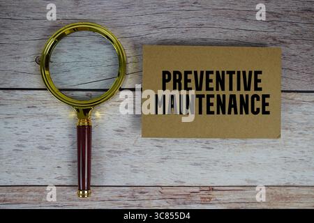 Preventive Maintenance text written on paper with magnifying glass Stock Photo