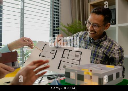 Engineers and contractors collaborate to solve problems that arise in design and construction, architects meets in the office to analyze the design st Stock Photo