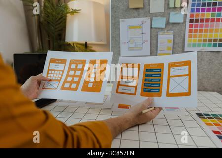 A web developer, as a User Experience and User Interface Officer, is designing beautiful and easy-to-use digital products that create a positive emoti Stock Photo