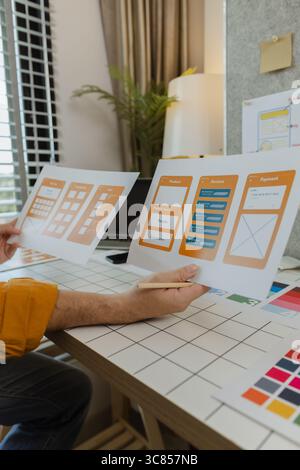 A web developer, as a User Experience and User Interface Officer, is designing beautiful and easy-to-use digital products that create a positive emoti Stock Photo