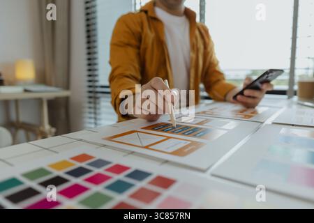 A web developer, as a User Experience and User Interface Officer, is designing beautiful and easy-to-use digital products that create a positive emoti Stock Photo