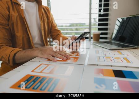 A web developer, as a User Experience and User Interface Officer, is designing beautiful and easy-to-use digital products that create a positive emoti Stock Photo