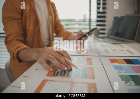 A web developer, as a User Experience and User Interface Officer, is designing beautiful and easy-to-use digital products that create a positive emoti Stock Photo