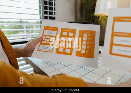 A web developer, as a User Experience and User Interface Officer, is designing beautiful and easy-to-use digital products that create a positive emoti Stock Photo
