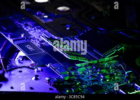 Macro Shot of Laptop RAM Modules and Cooling Fan on PCB with Blue and Purple Lighting Stock Photo