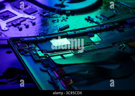 Macro View of Laptop Internal Components and PCB with Green and Blue Futuristic Accent Lighting Stock Photo