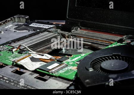 Close-Up of Dusty Laptop Cooling System with Heatsinks, Fan, and Circuit Board in Need of Cleaning Stock Photo