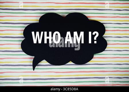 Who Am I? text with speech bubble top view on colorful stripes background Stock Photo