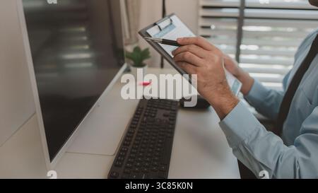 a businessman is sitting in his private office, an entrepreneur is working diligently, the chief accountant is reviewing documents and budget figures Stock Photo