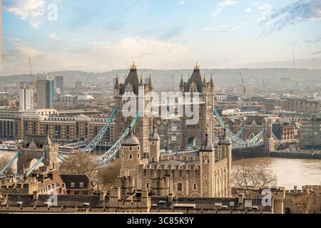 Wide view of Tower Bridge behind the Tower of London over the River Thames, London, England. Stock Photo